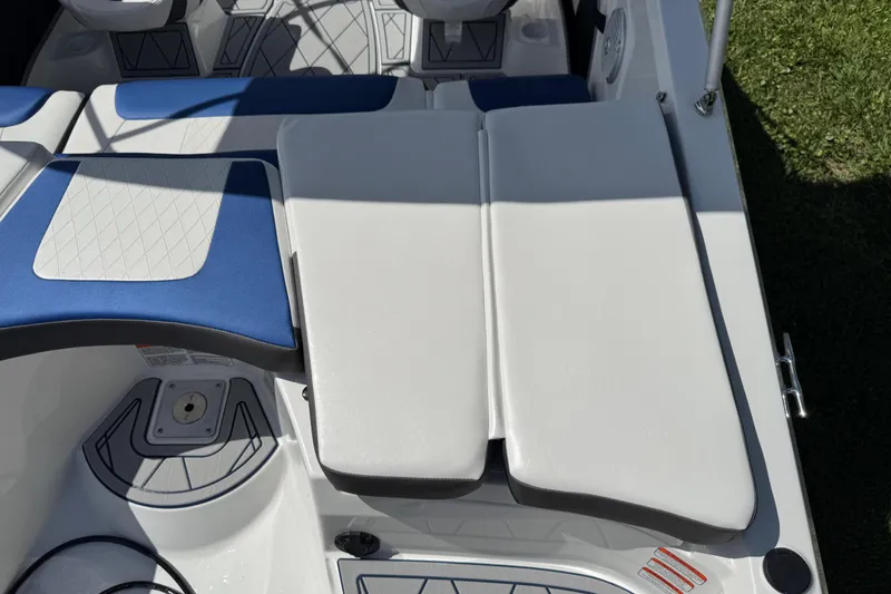 Slide: The Image of 2024 Tahoe 185 S boat interior with blue and white cushioned seating. - 34