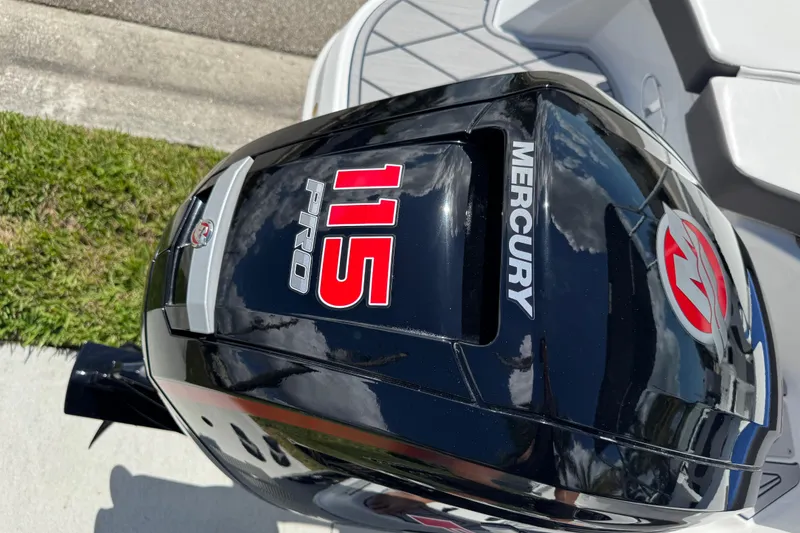 Slide: The Image of Mercury 115 Pro outboard motor on 2024 Tahoe 185 S boat, reflecting sky and clouds. - 36