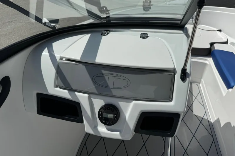 Slide: The Image of 2024 Tahoe 185 S boat dashboard with storage compartment and control panel. - 38