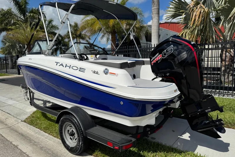 Slide: The Image of 2024 Tahoe 185 S boat with Mercury Pro XS engine, parked outdoors. - 4