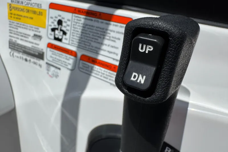 Slide: The Image of Close-up of 2024 Tahoe 185 S boat control lever with "UP" and "DN" buttons. - 41
