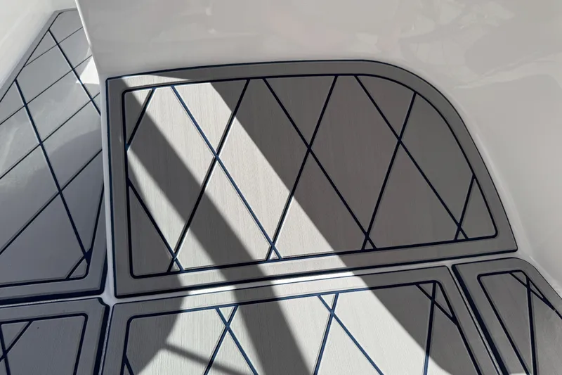 Slide: The Image of 2024 Tahoe 185 S boat deck with geometric pattern and shadow play. - 48