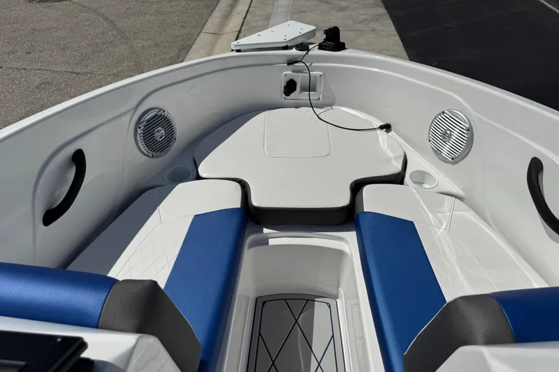 Slide: The Image of 2024 Tahoe 185 S boat interior with blue and white seating, speakers, and storage. - 53