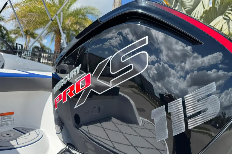 Slide: The Image of 2024 Tahoe 185 S boat with Mercury Pro XS 115 engine, reflecting sky and clouds. - 6