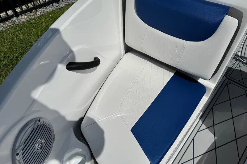 Slide: The Image of 2024 Tahoe 185 S boat interior with blue and white seating and speaker. - 61