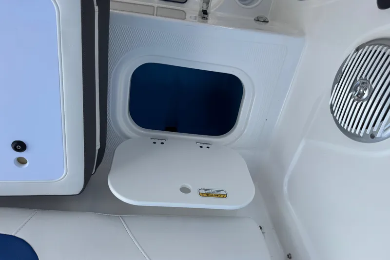 Slide: The Image of 2024 Tahoe 185 S boat interior with storage compartment and speaker. - 67