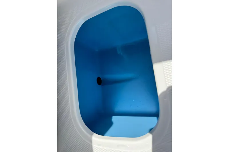 Slide: The Image of Interior view of 2024 Tahoe 185 S boat compartment, featuring a blue and white design. - 68