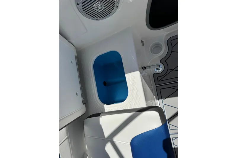 Slide: The Image of 2024 Tahoe 185 S boat interior with blue and white seating and storage compartment. - 69