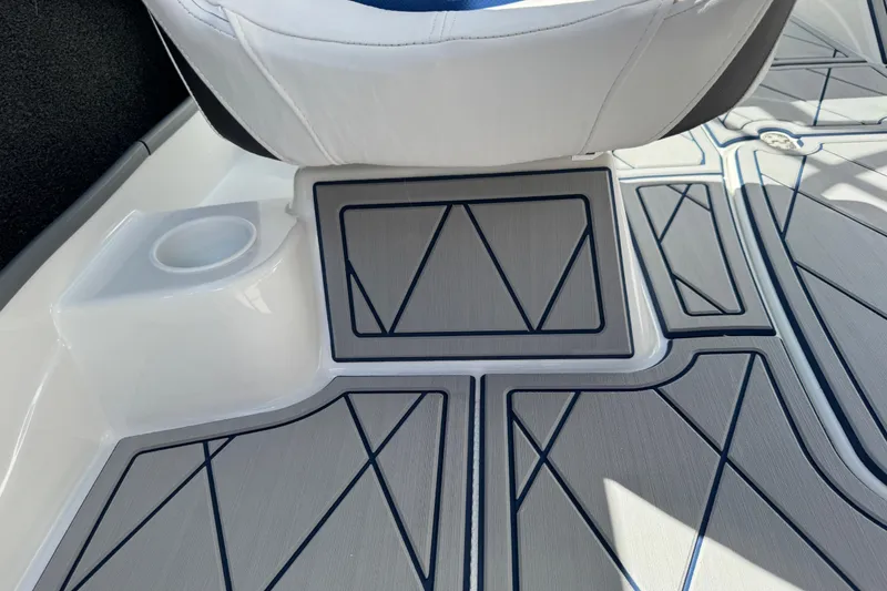 Slide: The Image of 2024 Tahoe 185 S boat interior with geometric-patterned flooring and white seating. - 71
