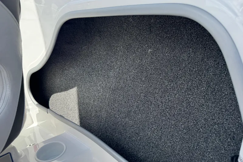 Slide: The Image of 2024 Tahoe 185 S boat interior with gray carpeted flooring. - 73