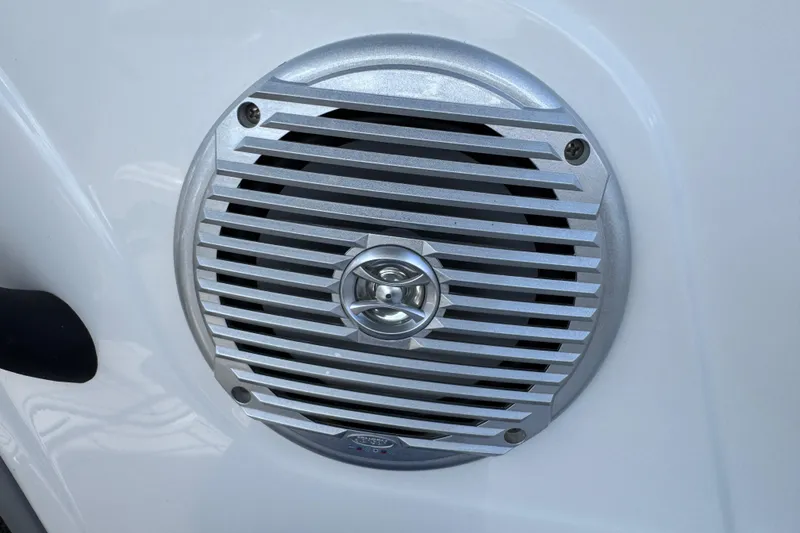 Slide: The Image of 2024 Tahoe 185 S boat speaker with silver grille on white surface. - 74