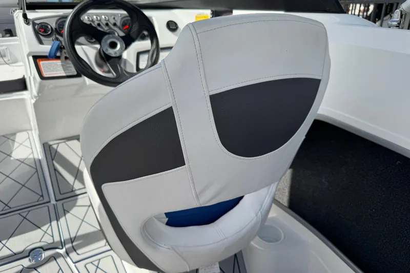 Slide: The Image of 2024 Tahoe 185 S boat interior with steering wheel and seat detail. - 76