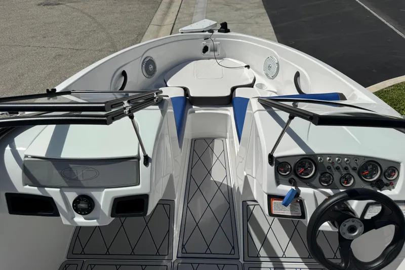 Slide: The Image of 2024 Tahoe 185 S boat interior with steering wheel, dashboard, and seating area. - 79