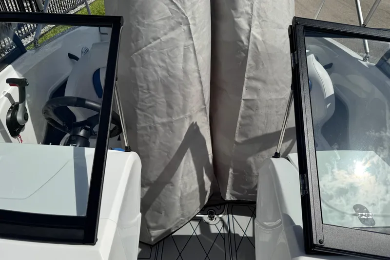 Slide: The Image of 2024 Tahoe 185 S boat interior with steering wheel and seating area. - 81