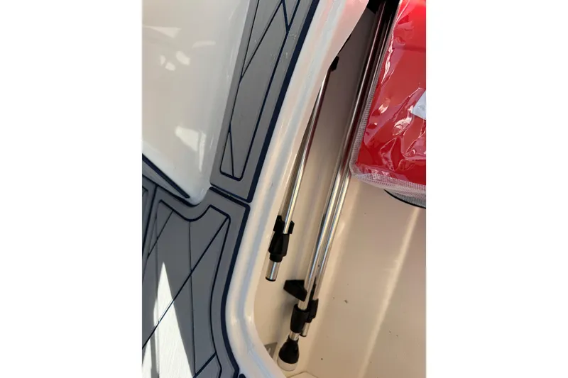 Slide: The Image of 2024 Tahoe 185 S boat interior with storage compartment and hydraulic struts. - 84