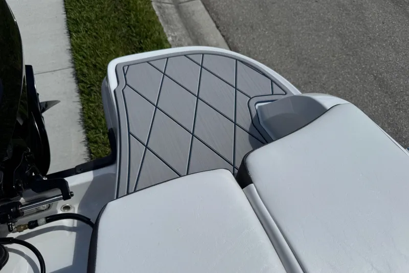 Slide: The Image of 2024 Tahoe 185 S boat deck with cushioned seating and textured flooring. - 86