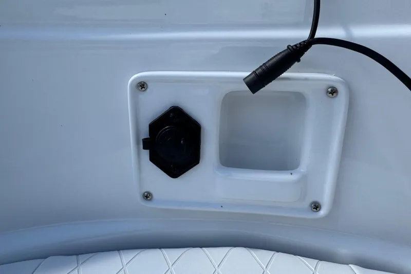 Slide: The Image of 2024 Tahoe 185 S boat detail showing a power outlet and cable connection. - 88