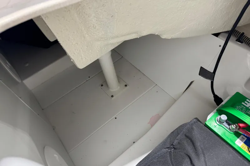 Slide: The Image of 2024 Tahoe 185 S boat interior showing battery compartment and wiring. - 98