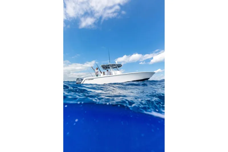 Slide: The Image of 2026 Contender 32 ST boat cruising on open ocean under clear blue sky. - 10
