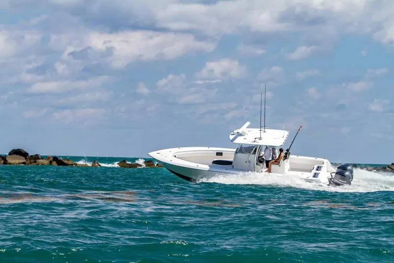 Slide: The Image of 2026 Contender 32 ST boat cruising on open water under a partly cloudy sky. - 9