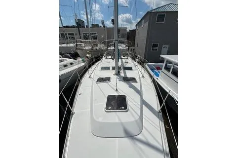Slide: The Image of 2006 Beneteau 373 sailboat docked, showcasing sleek deck design and rigging. - 11