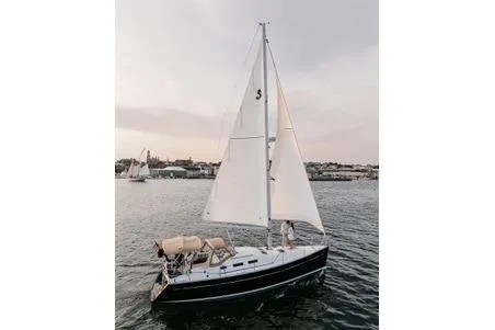 Slide: The Image of 2006 Beneteau 373 sailboat cruising on calm waters at sunset. - 14