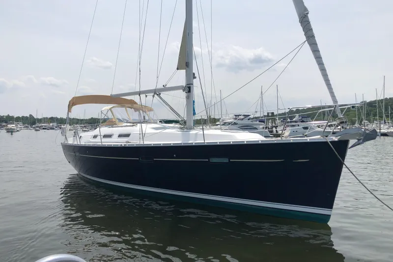 Slide: The Image of 2006 Beneteau 373 sailboat docked in a marina, calm waters, overcast sky. - 2