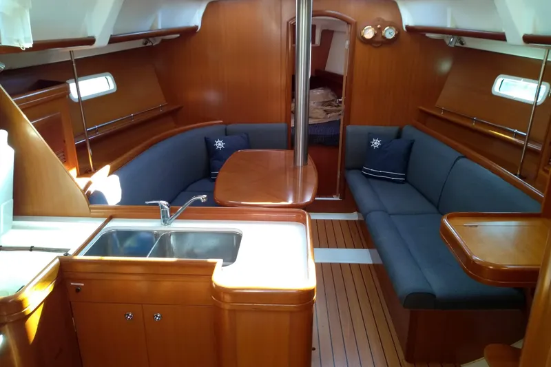 Slide: The Image of Interior of 2006 Beneteau 373 sailboat with cozy seating and wooden finishes. - 3
