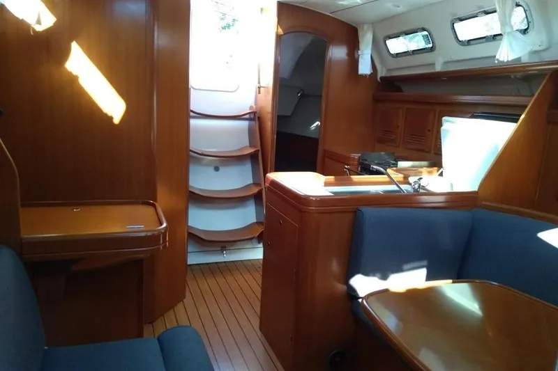 Slide: The Image of Interior of 2006 Beneteau 373 sailboat with wood finish and cozy seating area. - 4