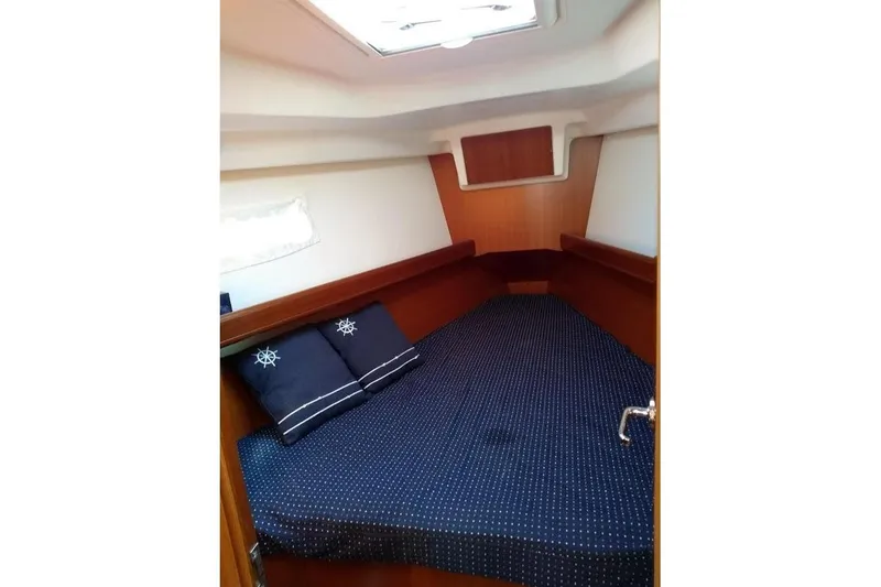 Slide: The Image of Interior of 2006 Beneteau 373 sailboat with wooden finish and blue seating. - 5