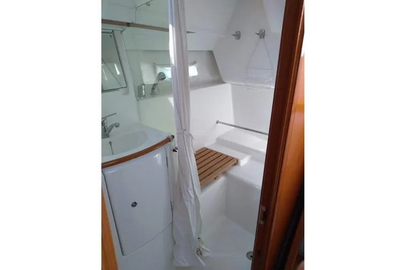Slide: The Image of Cozy cabin interior of 2006 Beneteau 373 sailboat with bedding and pillows. - 6