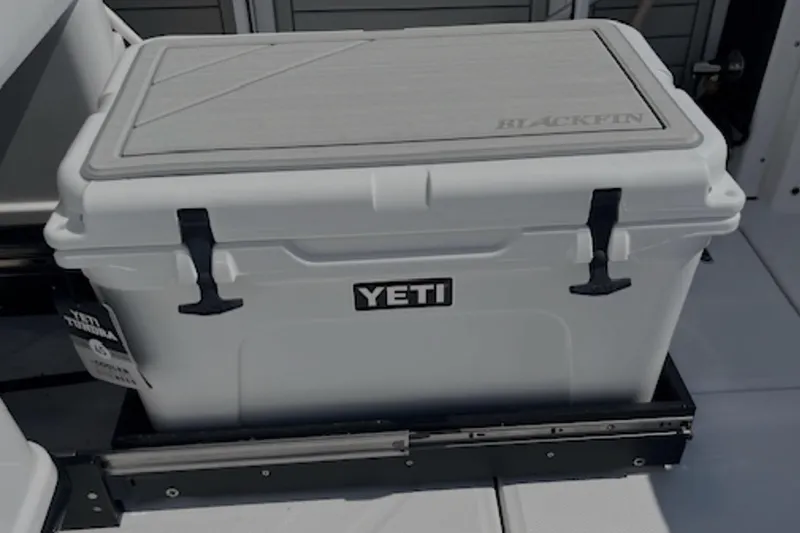 Slide: The Image of YETI cooler on 2024 Blackfin 302 DC boat deck, featuring secure latches. - 16