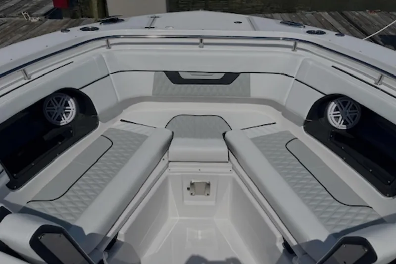 Slide: The Image of Luxurious seating area on a 2024 Blackfin 302 DC boat, featuring modern design and speakers. - 17