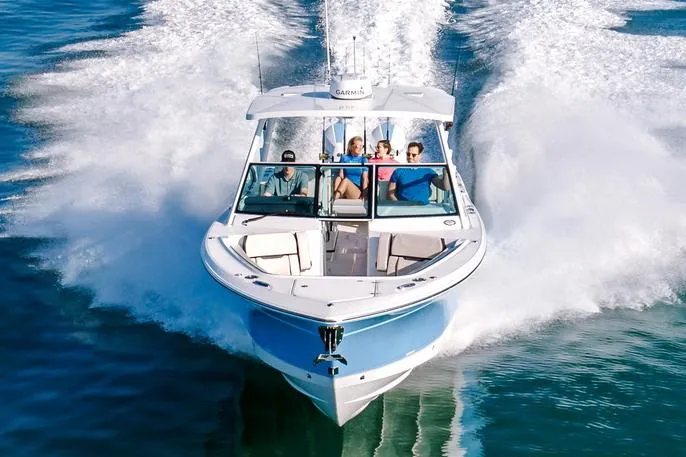 Slide: The Image of 2024 Blackfin 302 DC boat docked in a marina, showcasing sleek design and modern features. - 2