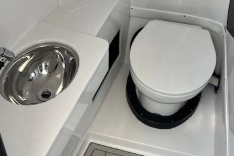 Slide: The Image of 2024 Blackfin 302 DC boat bathroom with stainless steel sink and toilet. - 20