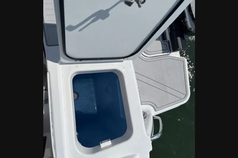Slide: The Image of 2024 Blackfin 302 DC boat with open storage compartment on deck. - 21