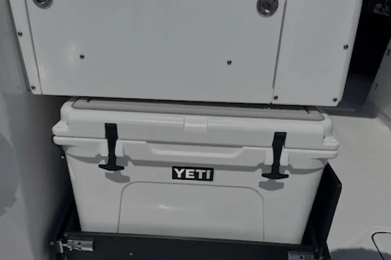 Slide: The Image of 2024 Blackfin 302 DC with Yeti cooler in storage compartment. - 23