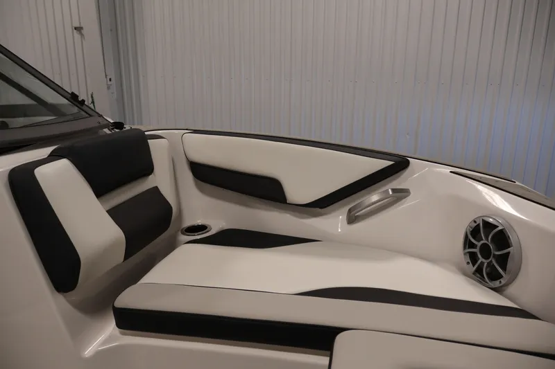 Slide: The Image of 2020 Yamaha Boats 195S interior seating with black and white upholstery, speaker, and cup holder. - 13