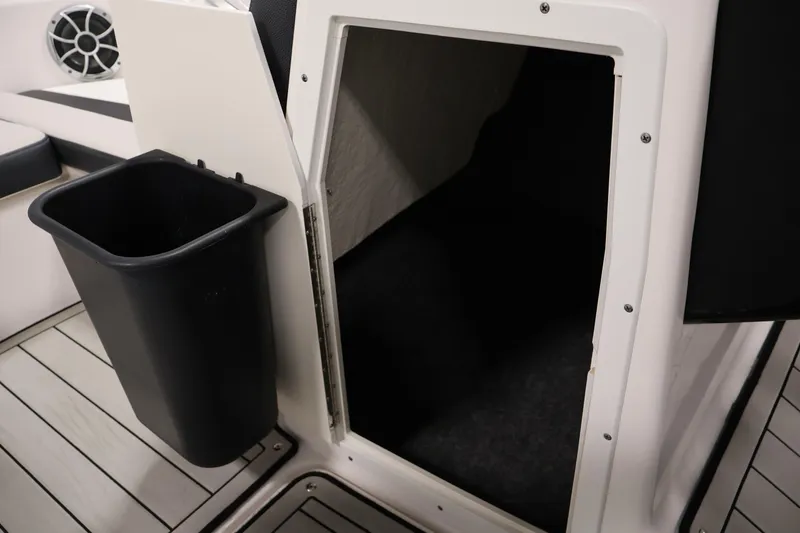 Slide: The Image of 2020 Yamaha Boats 195S interior storage compartment with trash bin and speaker. - 18