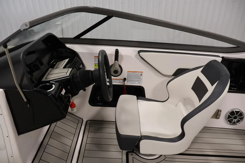 Slide: The Image of 2020 Yamaha Boats 195S cockpit with steering wheel and white captain's chair. - 19