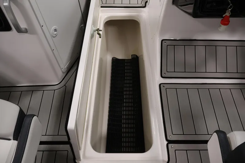 Slide: The Image of 2020 Yamaha Boats 195S interior storage compartment with sleek flooring design. - 32