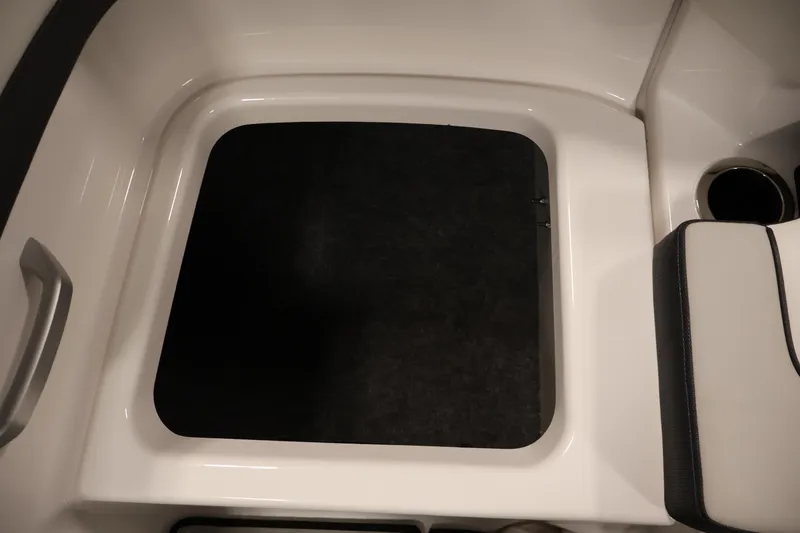 Slide: The Image of 2020 Yamaha Boats 195S interior storage compartment with cup holder and seating. - 40