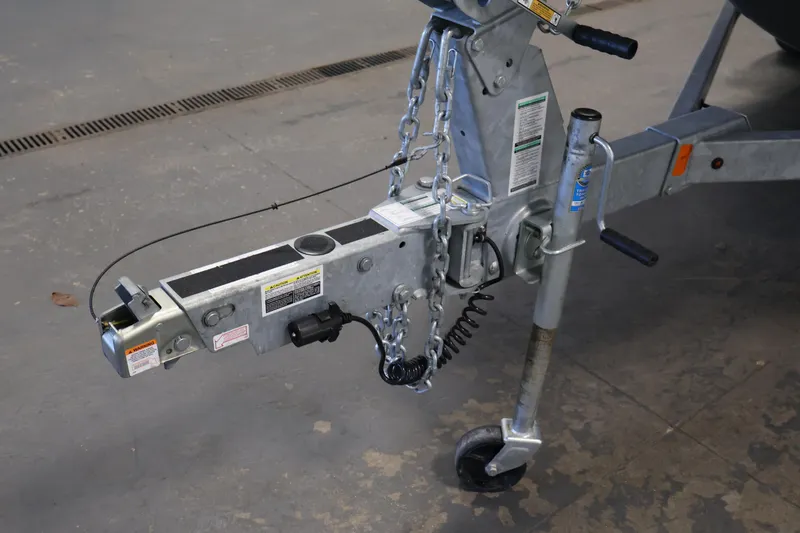 Slide: The Image of Trailer hitch of a 2020 Yamaha Boats 195S, featuring safety chains and a jack wheel. - 47