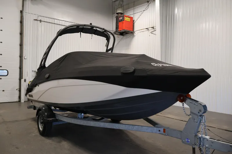 Slide: The Image of 2020 Yamaha Boats 195S covered and on trailer in indoor storage. - 50
