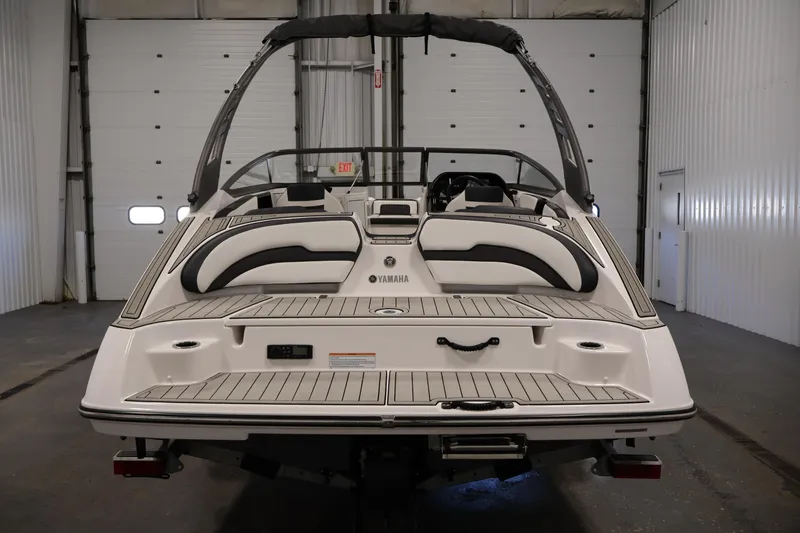 Slide: The Image of 2020 Yamaha Boats 195S in a garage, showcasing sleek design and spacious seating. - 6