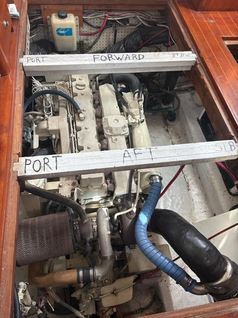 Slide: The Image of 1983 Wilbur 38 Flybridge engine room with labeled directions. - 34
