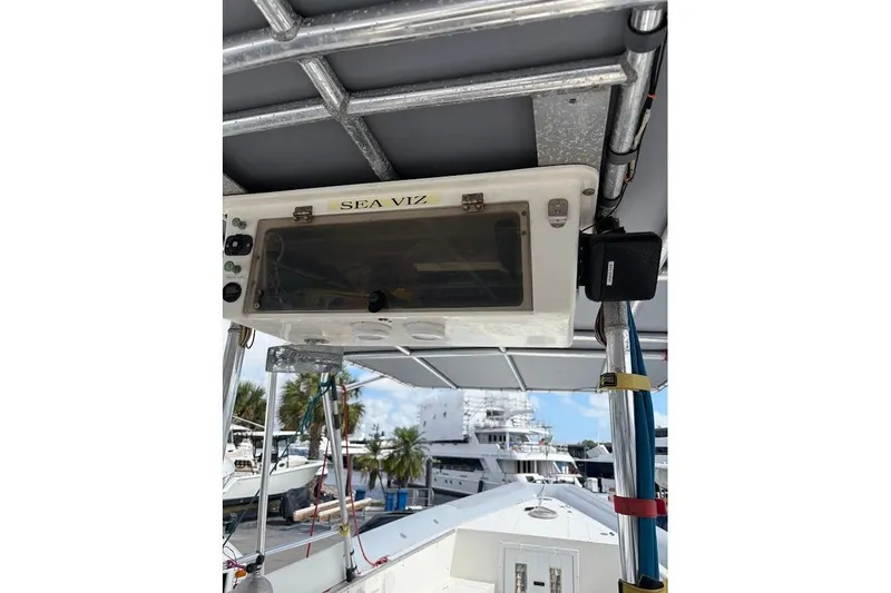 Slide: The Image of 2009 Eduardono RIB boat console with "SEA VIZ" label, docked near yachts. - 15
