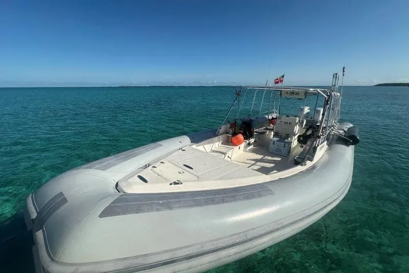 Slide: The Image of 2009 Eduardono RIB boat floating on clear turquoise water under a blue sky. - 3