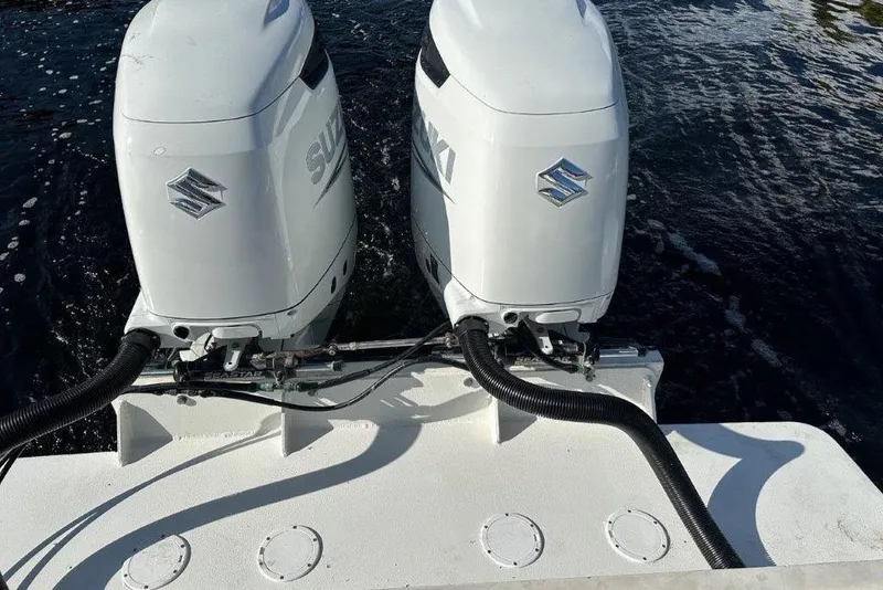 Slide: The Image of Twin Suzuki outboard motors on 2009 Eduardono RIB boat, water background. - 8