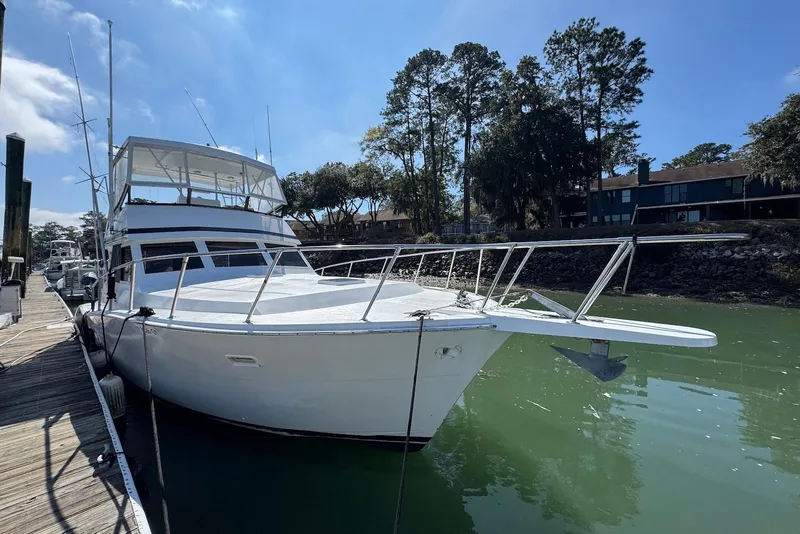 The Image of 1988 Viking 41 Convertible yacht docked in a serene marina setting. - 0